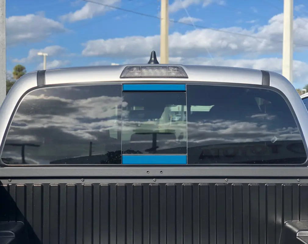 Gray rear power sliding window accent overlays for 2016-2023 Toyota Tacoma, featuring a subtle and modern design.