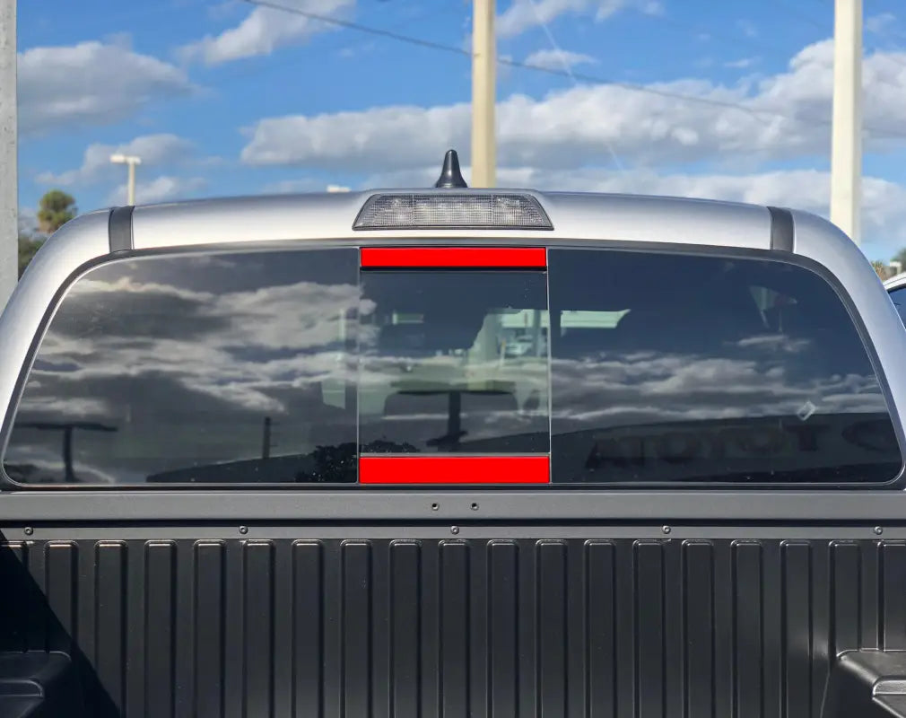 Silver rear power sliding window accent overlays for 2016-2023 Toyota Tacoma, enhancing the vehicle's polished appearance.