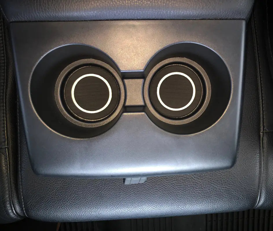 Close-up view of rear seat cup holder inserts in a 2007-2021 Toyota Tundra, showcasing durable black foam with white circular detailing.