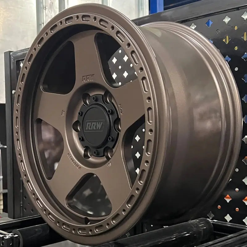 Bronze-colored off-road wheel from RG4-H Hybrid MonoForged Series with embossed ABS and lug nuts