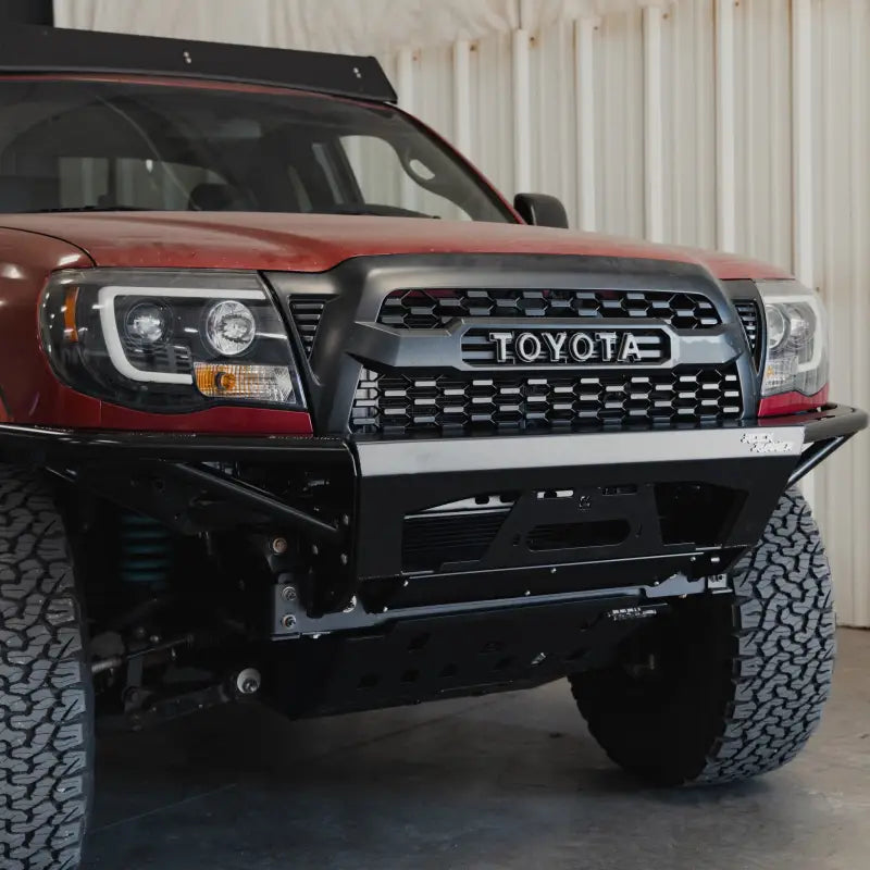 Front angled view of a 2005-2015 Toyota Tacoma with the Rock Runner modular bumper and integrated control features.