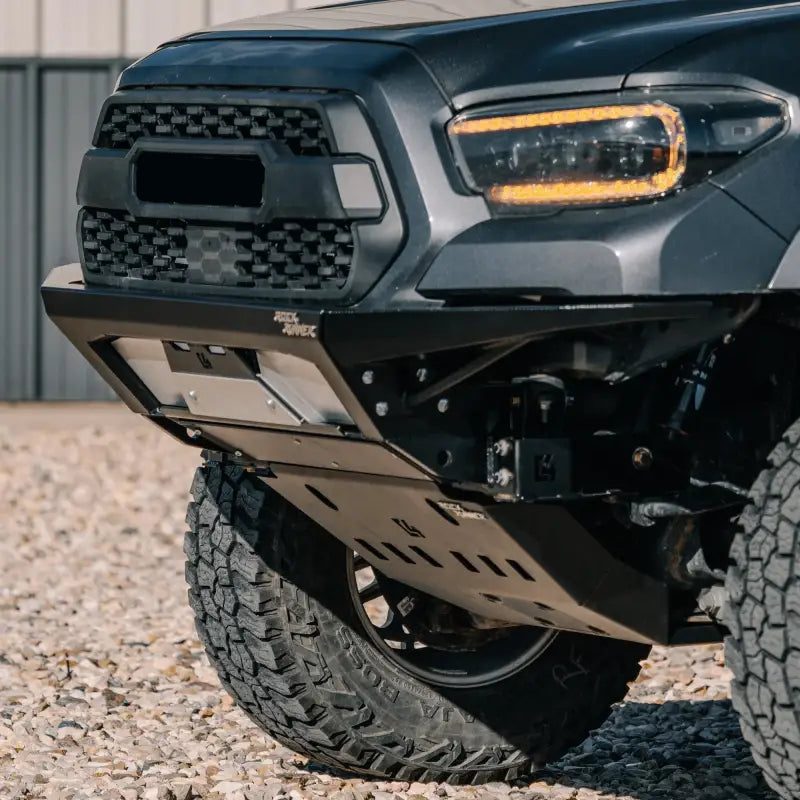 Tacoma front skid plate installed on a 2016+ 3rd Gen truck, showcasing off-road protection with steel construction and oil access.