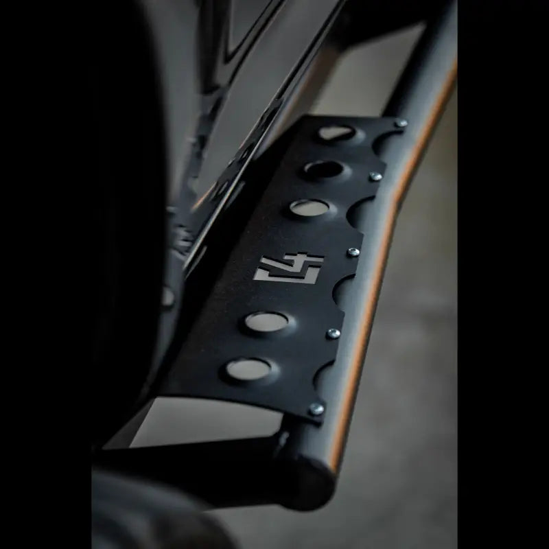Detailed shot of 4Runner Rock Sliders with a laser-cut logo, durable steel construction, and a bolt-on installation for 5th Gen models.