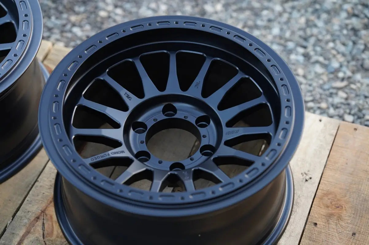Black multi-spoke wheel from RS7-H Hybrid MonoForged Series with lug nuts and center caps