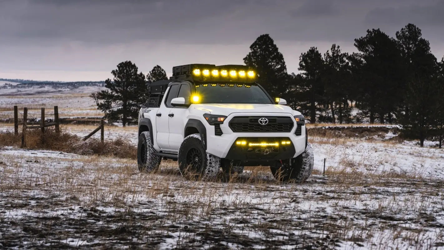 White Toyota Tacoma with off-road modifications and RS7-H Hybrid MonoForged Wheel Matte Bronze focus keywords