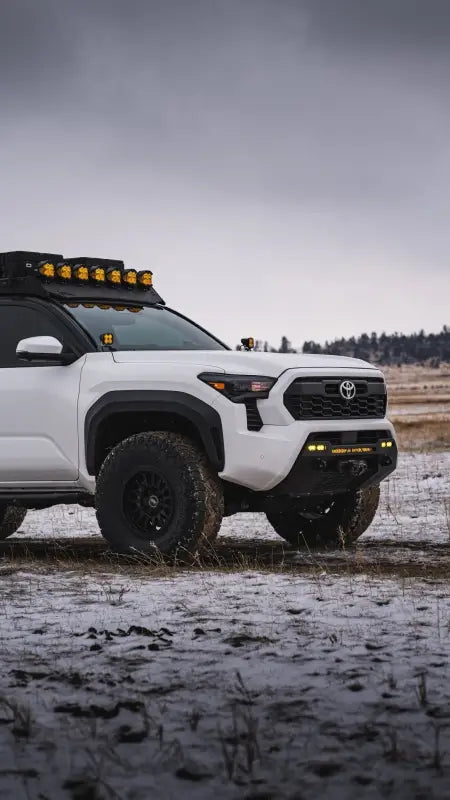 White Toyota truck with off-road modifications featuring RS7-H Hybrid MonoForged Wheel in Matte Bronze and lug nuts
