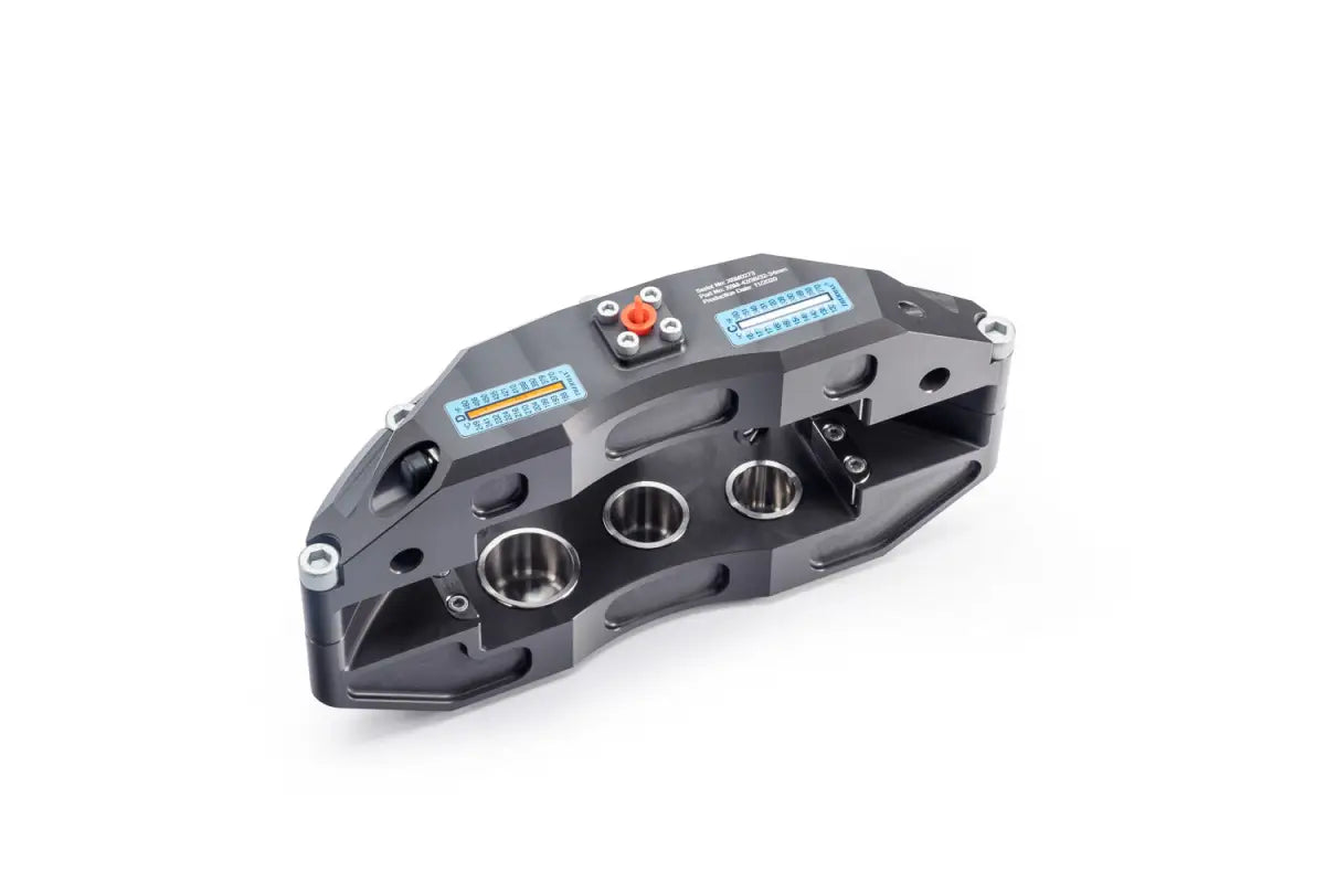 Angled view of the 6-piston caliper from the Wrangler JL Stage-1 big brake kit, featuring technical markings and robust construction.