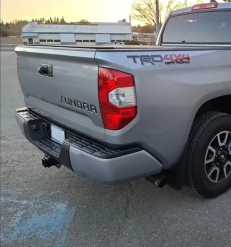 Silver Toyota Tundra pickup truck with chrome bumper caps and standard rear bumper caps