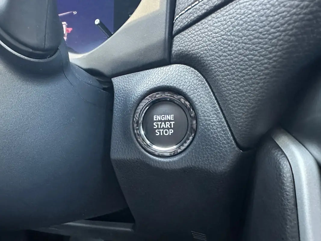 Close-up of Start Button Accent Trim fitted on a 2019-2024 Toyota Rav4, showcasing its stylish and precise fit around the engine start/stop button.