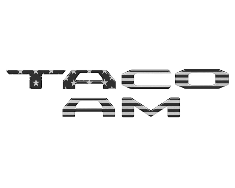 Black and gray American flag-themed tailgate letter inserts for 2024-2025 Toyota Tacoma, offering a patriotic and stylish upgrade.