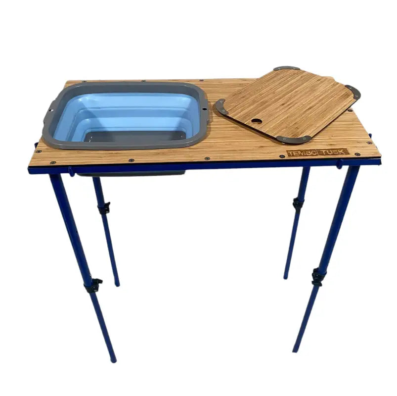 TemboTusk Camp Table Kit with collapsible blue basin, bamboo top, and adjustable blue legs. Ideal for camping and outdoor use.