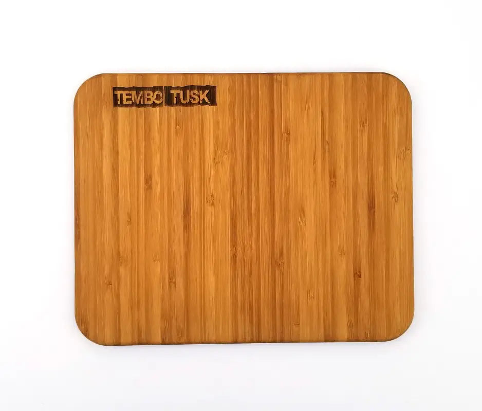 Close-up of the TemboTusk bamboo charcuterie board, showcasing its smooth, pre-oiled surface and engraved logo for a premium finish.