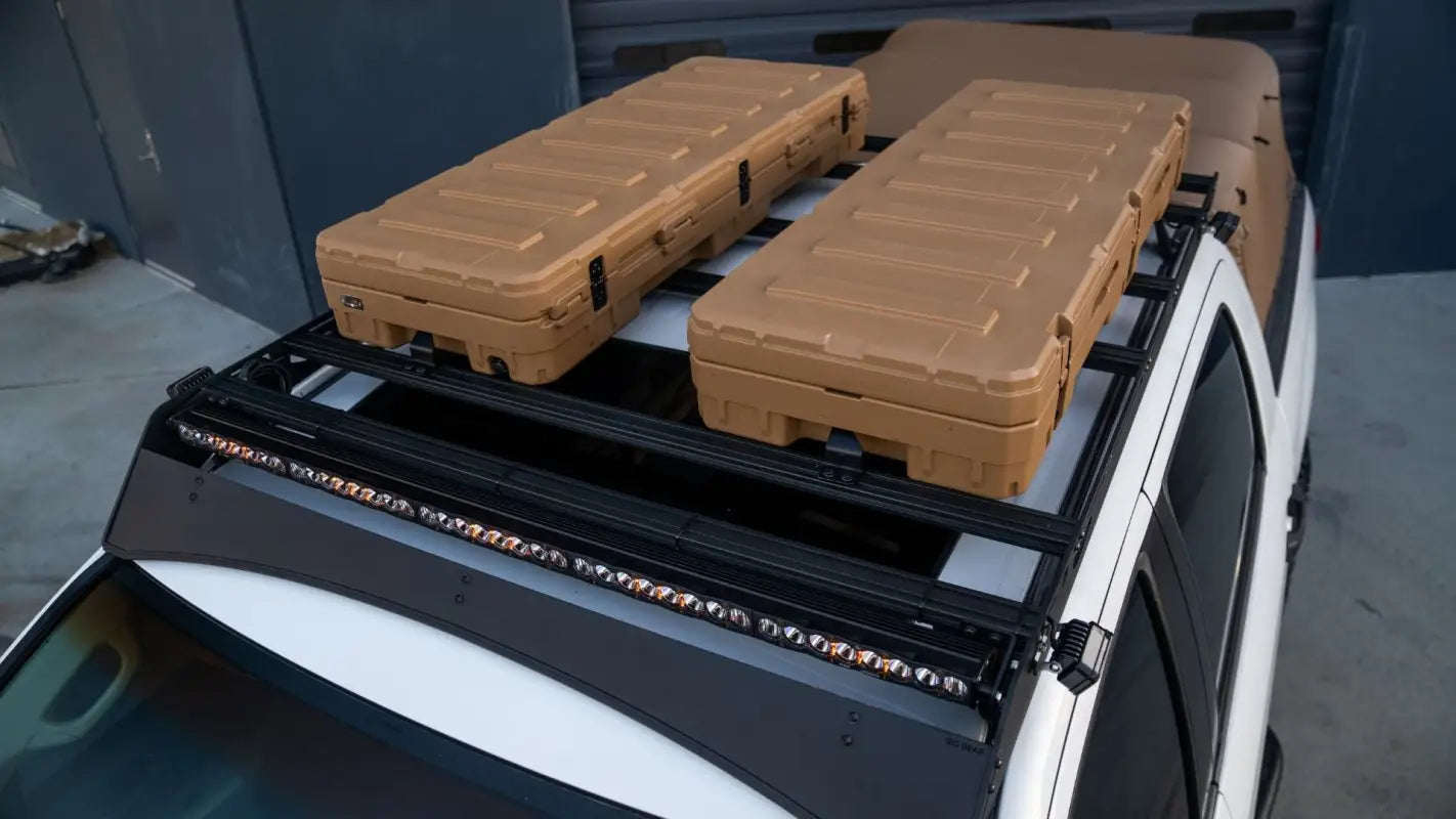 Top view of Big Bear Roof Rack on Toyota Tundra, equipped with mounted cargo cases and secure aluminum crossbars.