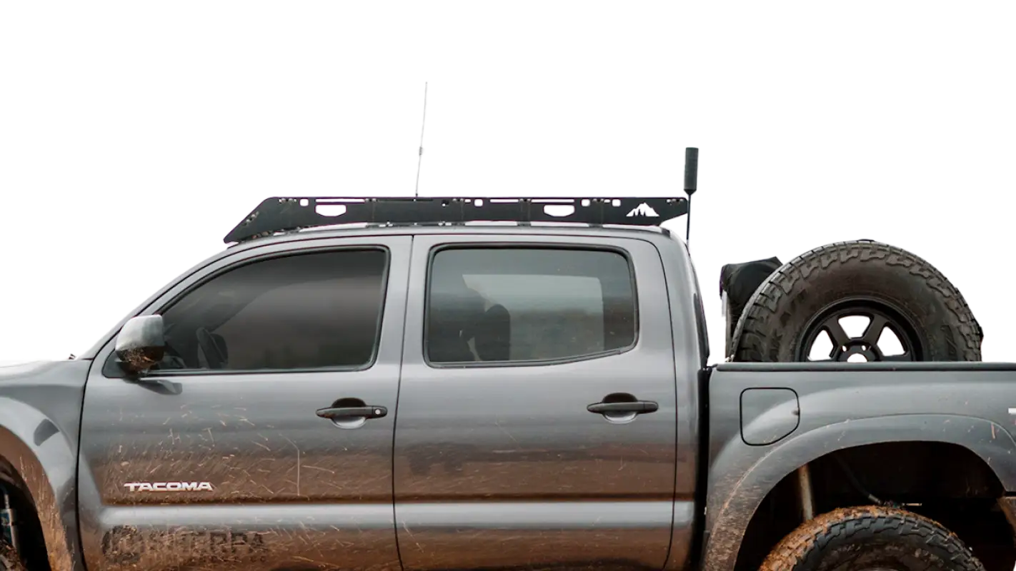 Close-up side view of the Grand Teton roof rack mounted on a Toyota Tacoma Double Cab, highlighting its durable and secure design.