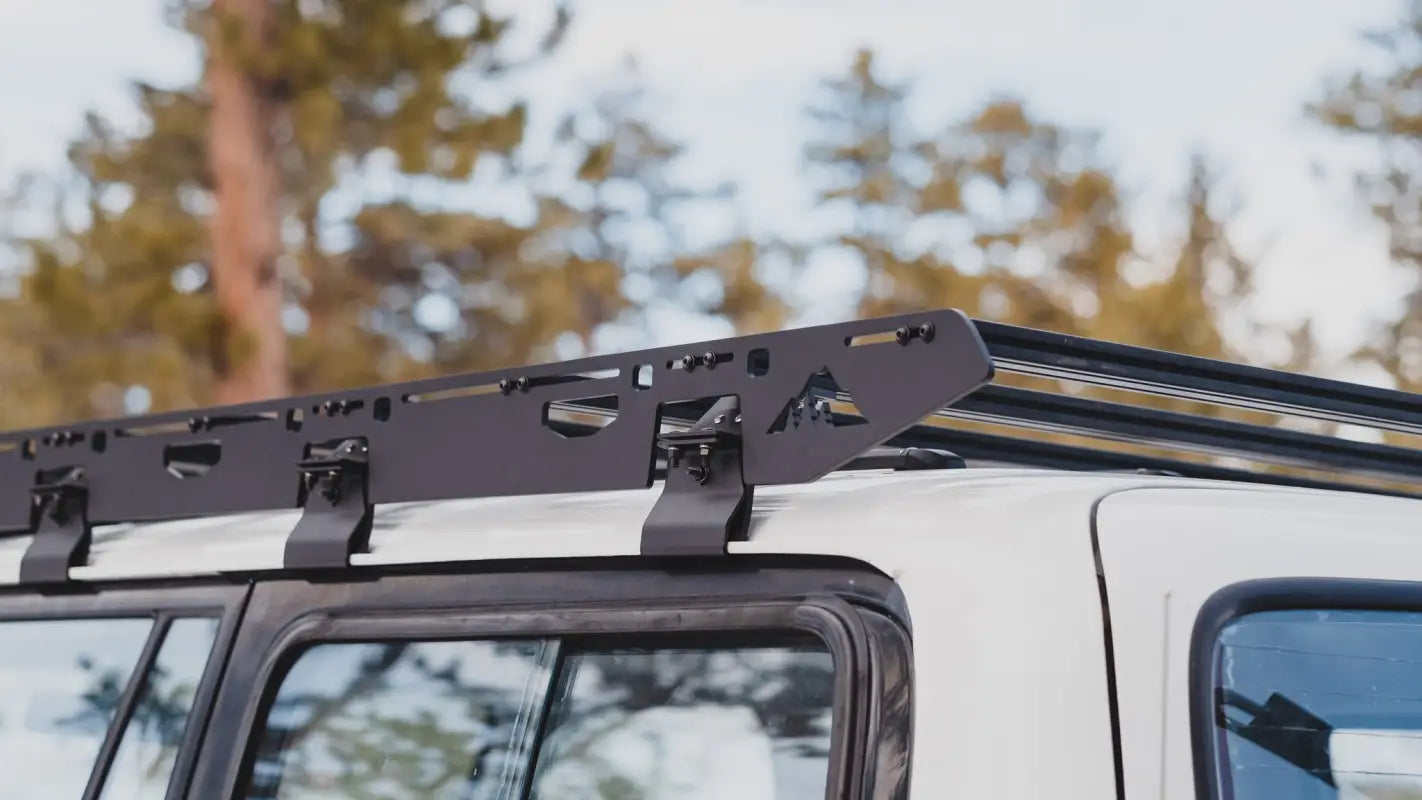Side view of the La Sal roof rack on an 80 Series Land Cruiser, featuring multiple crossbars and a rugged aluminum build.