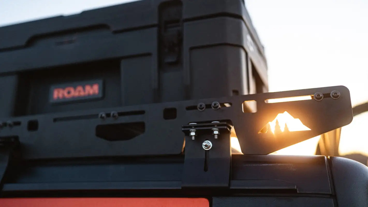 Close-up of The Sunlight roof rack's side bracket on Jeep Gladiator JT, featuring a mountain cutout design and secure mounting system.
