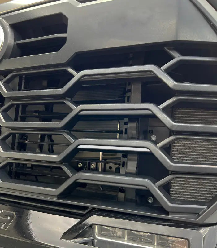 Toyota Tundra or Sequoia grille without TRD tri-color line inserts, showcasing the original grille design.