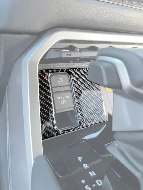 Upper center console accent trim with carbon fiber design installed in a 2022-2024 Toyota Tundra or 2023-2024 Toyota Sequoia interior.