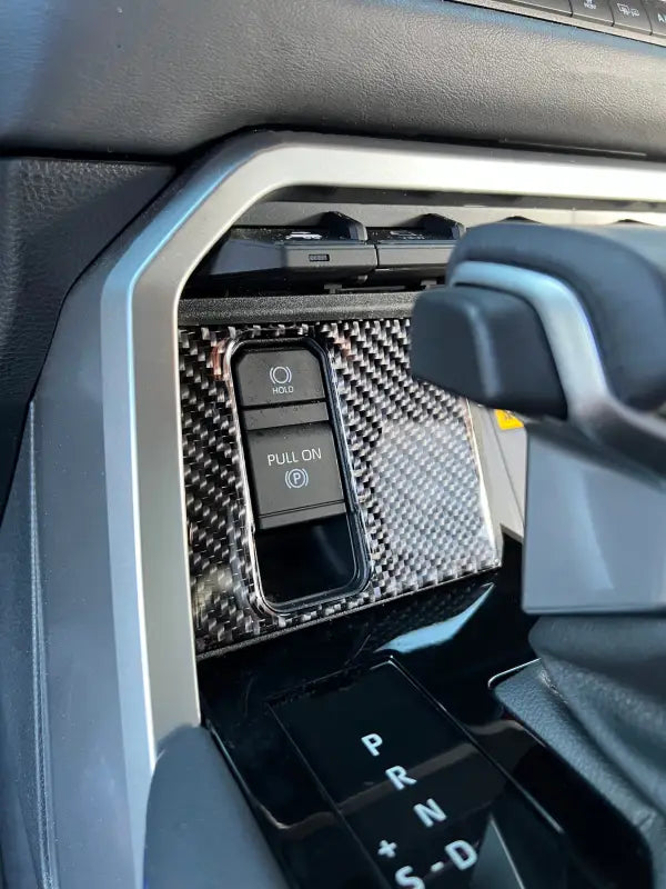 Close-up of carbon fiber upper center console accent trim fitted in a Toyota Tundra or Sequoia, enhancing the vehicle's interior decor.