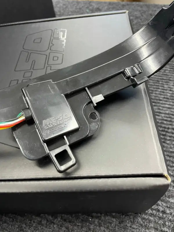 Close-up of V5 Switchback Signal component with Mesa Customs branding, highlighting durable construction and wiring details.