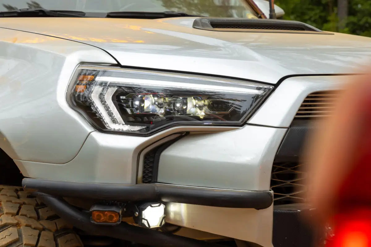Silver SUV headlight featuring Evo headlights with high beam and turn signals for 14-24 4Runner