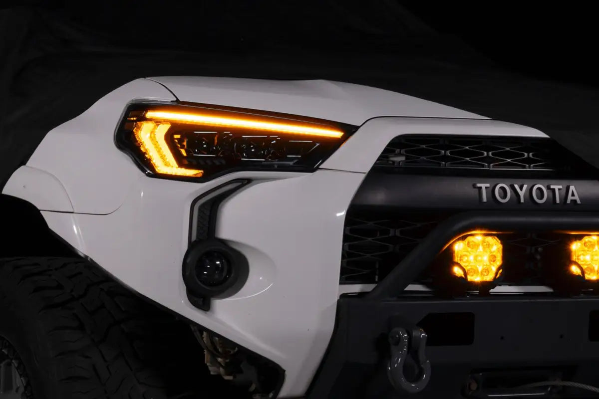 White Toyota 4Runner with XB Evo Headlights featuring aftermarket high beam and turn signals