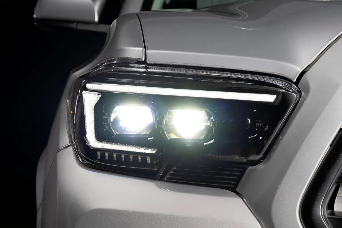 Illuminated XB Evo Hybrid Headlights for 16-23 Tacoma showing bright hybrid headlights