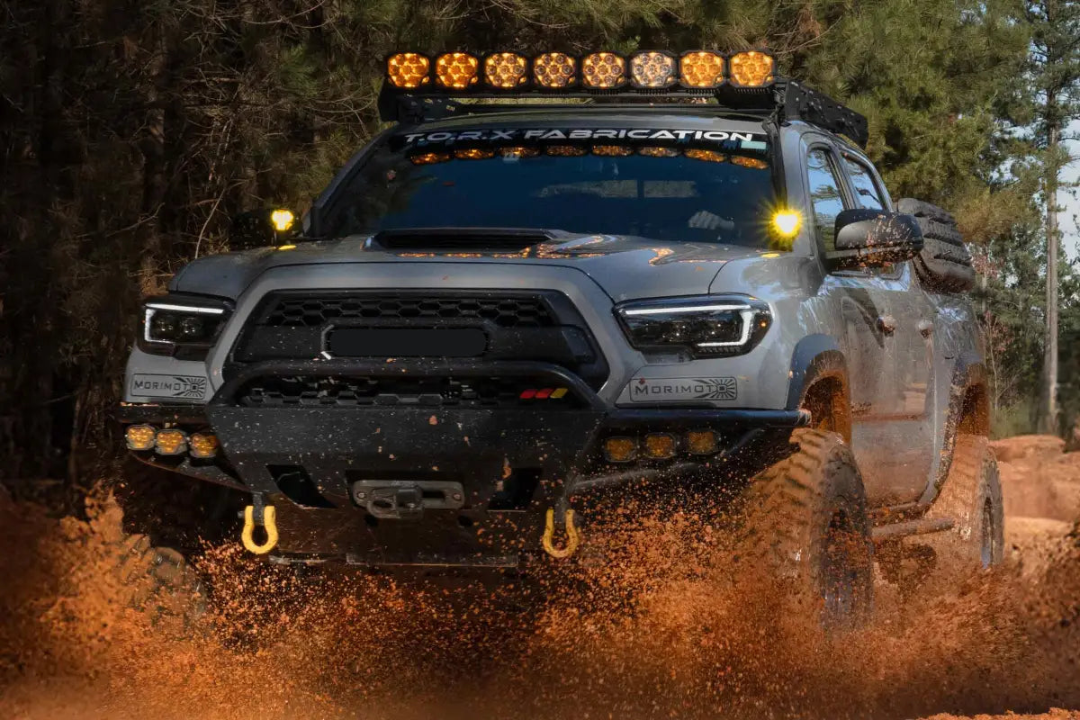 Gray Toyota Tacoma off-roading with XB Evo Hybrid Headlights for 16-23 Tacoma