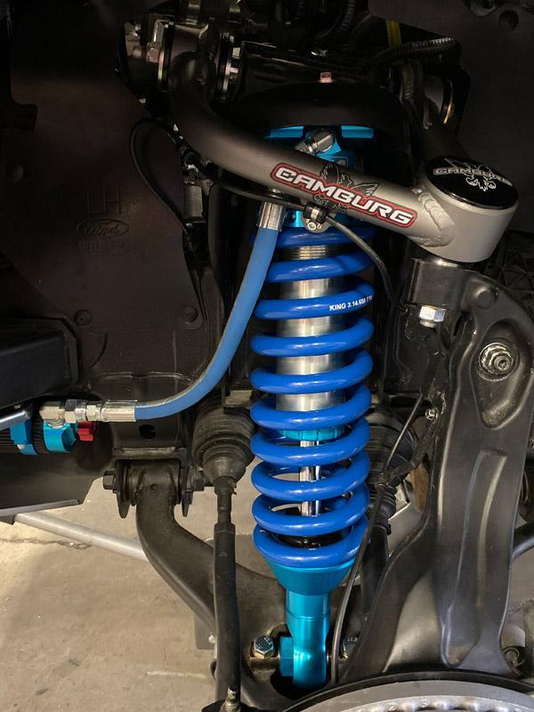 Installed 19-23 Ford Ranger coilover kit showcasing blue anodized shocks and springs, enhancing suspension and wheel travel.